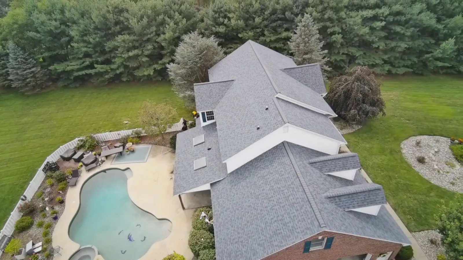 Aerial view of a finished Owens Corning Duration Harbor Blue roof on a poolside home in Nazareth, PA by LV Roofing & Siding