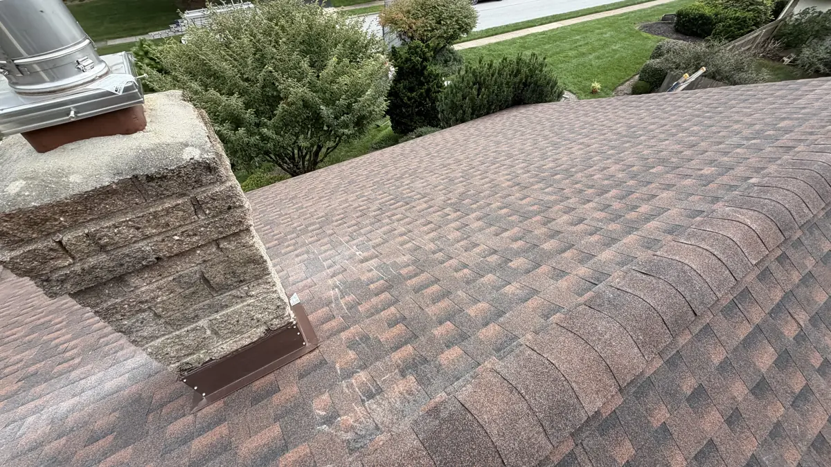 New chimney flashing and ridge on a shingle roof by LV Roofing & Siding
